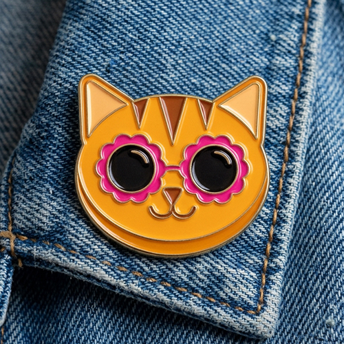 Image of Marmalade the cat wearing sunglasses peeking from behind a pink envelope.